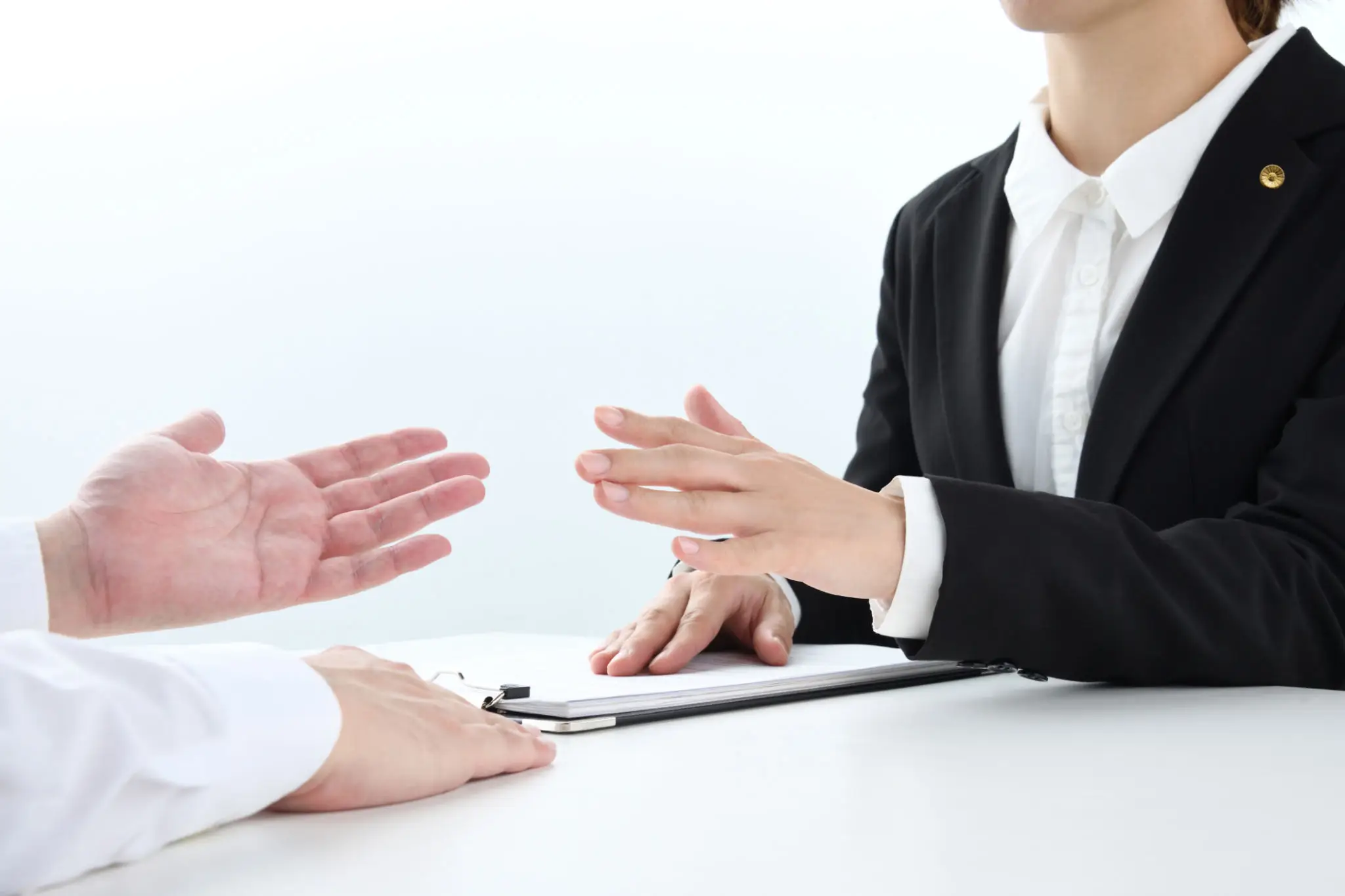 Two people discussing documents in a business setting.